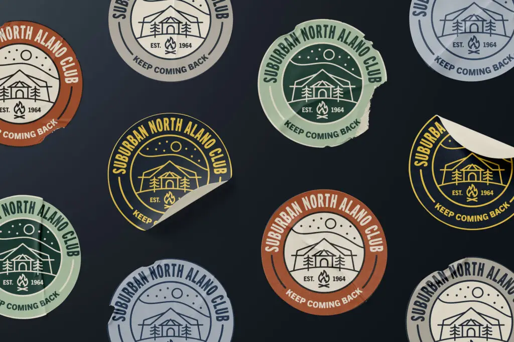 logo badge stickers in multiple colors laid out on a flat surface