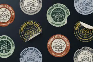 logo badge stickers in multiple colors laid out on a flat surface